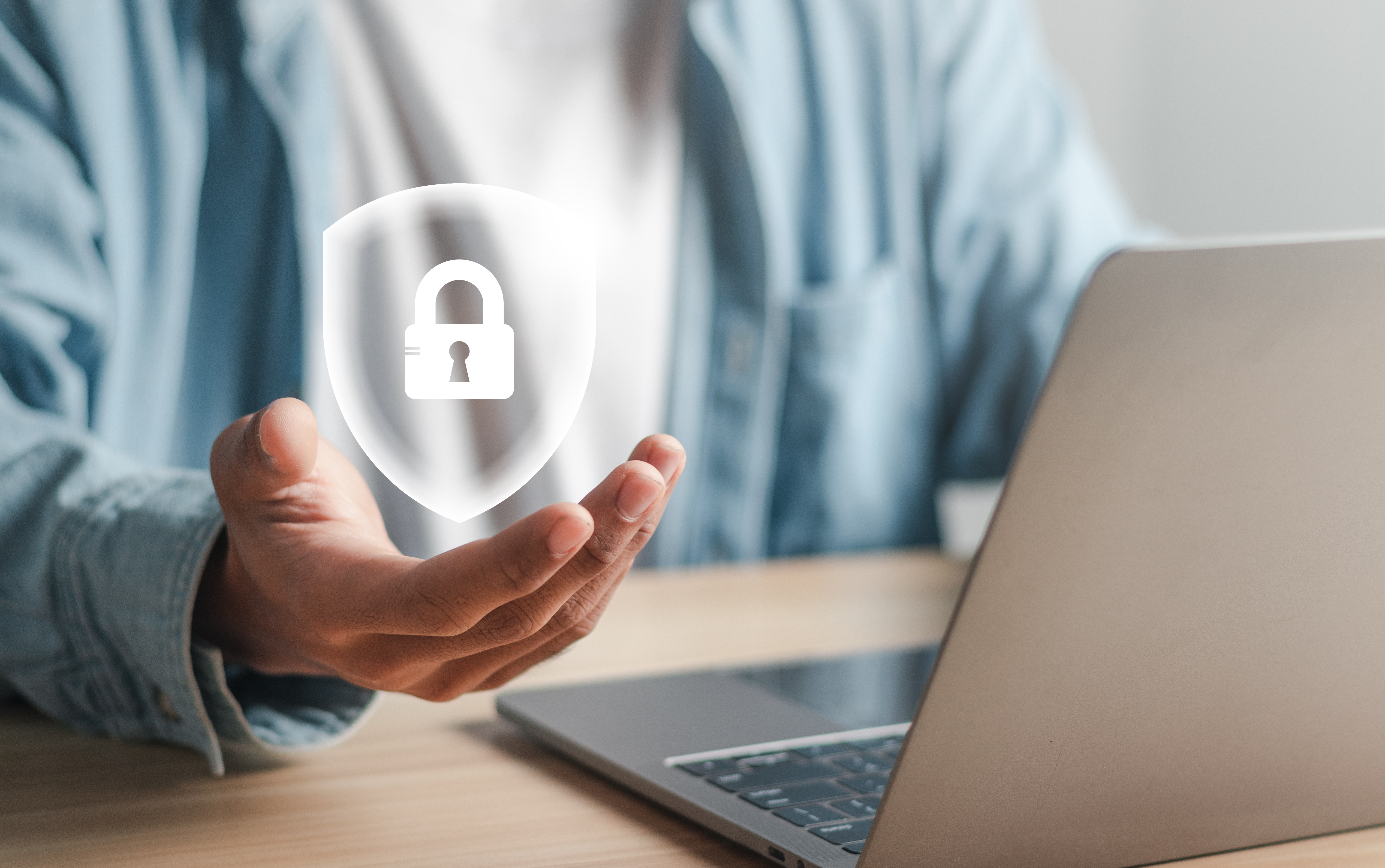 Businessman holding shield with lock icon. Security concept. Maximum protection from cyber attacks Digital Crime and Data Privacy on the Internet.